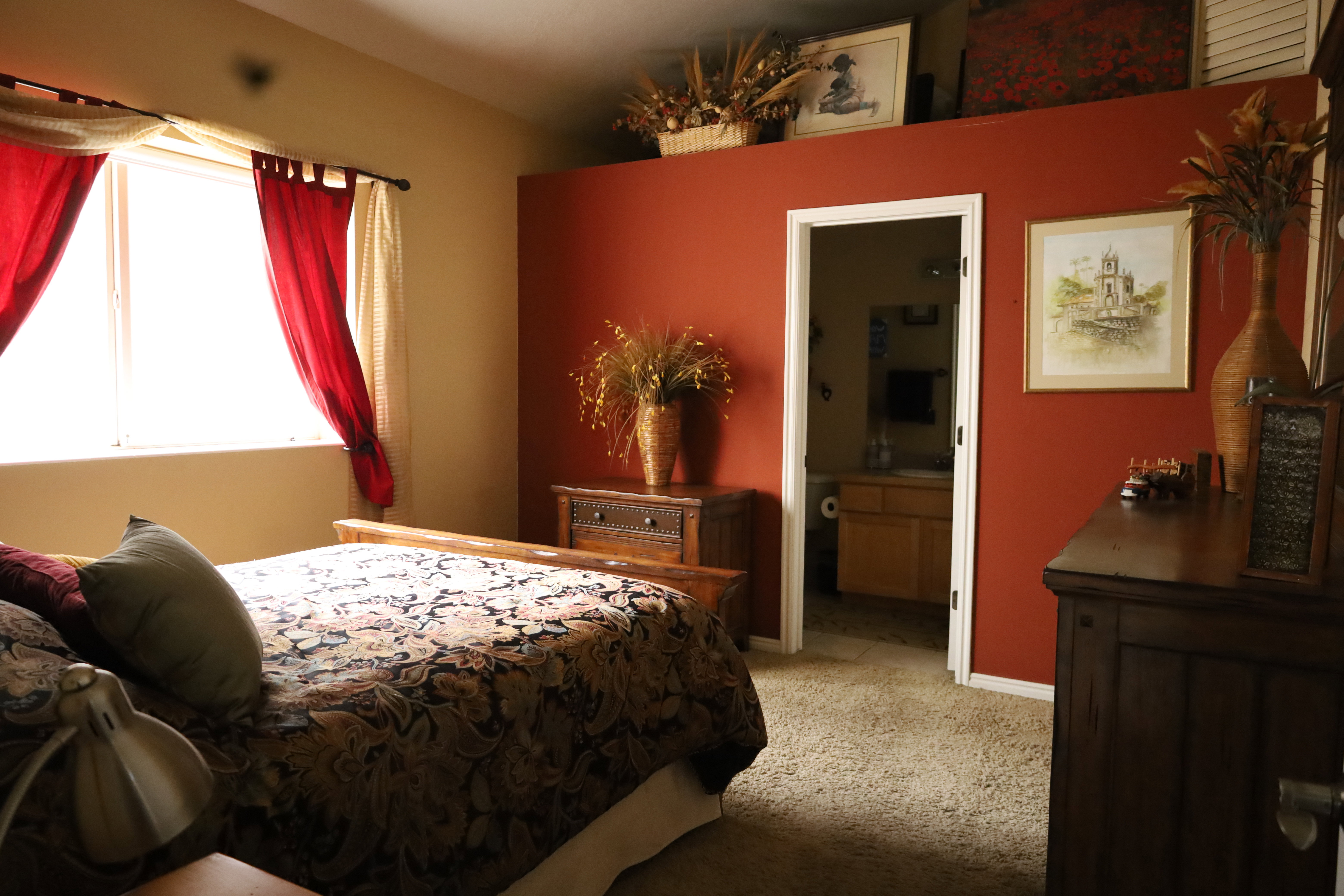 Bedroom with light colored carpet and ensuite bath