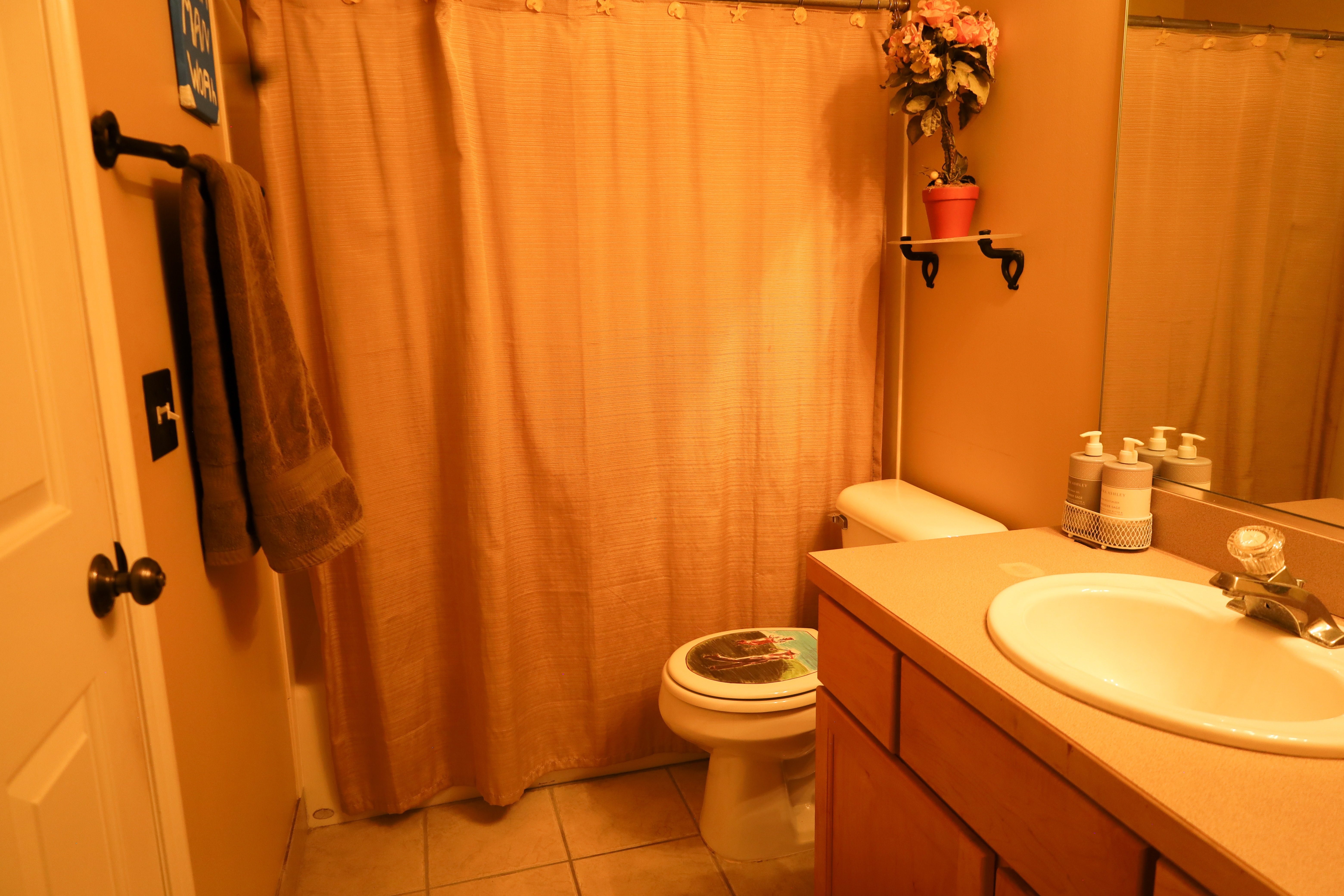 Bathroom featuring vanity, curtained shower, and light tile patterned floors