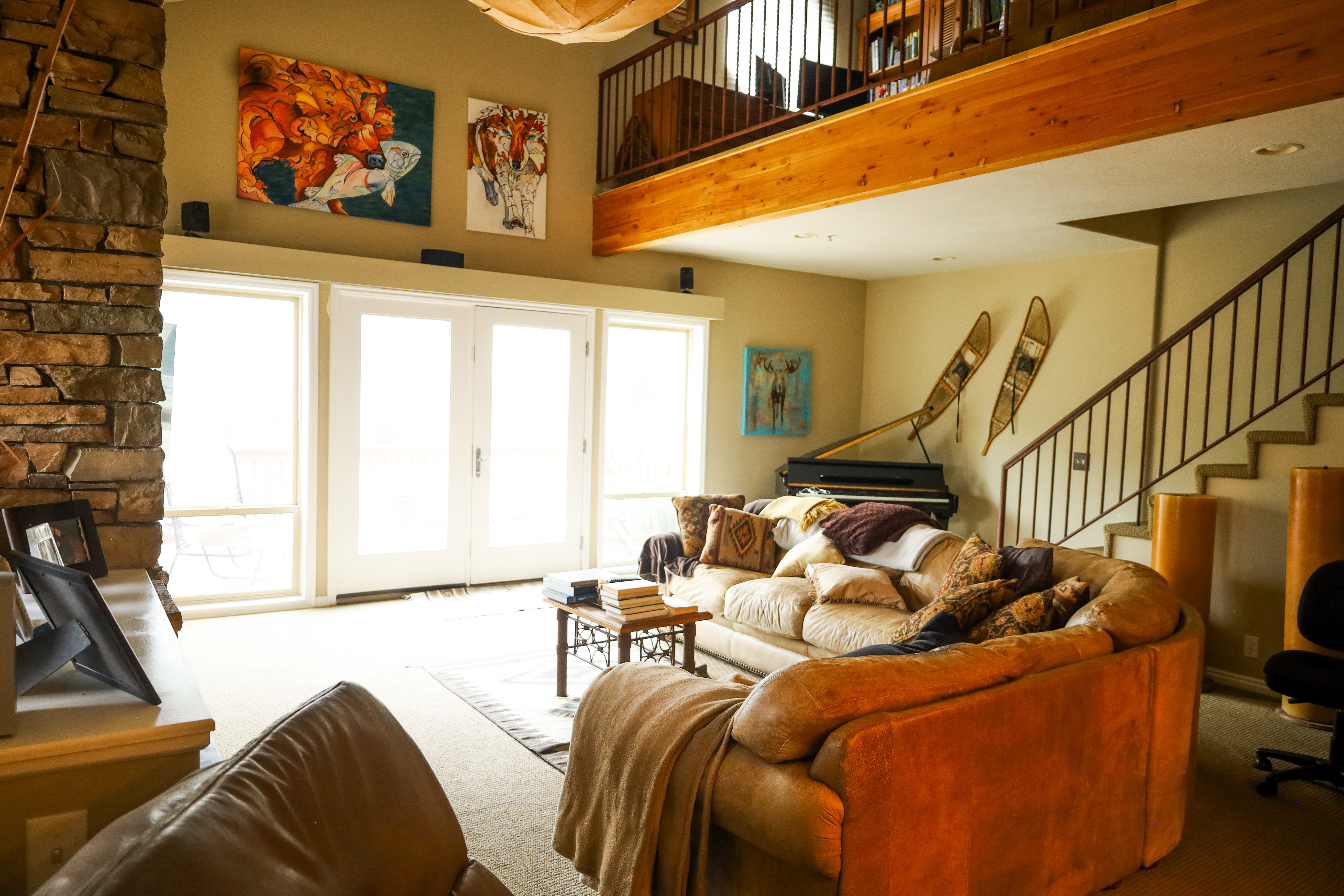 Living area featuring carpet flooring, a high ceiling, and french doors