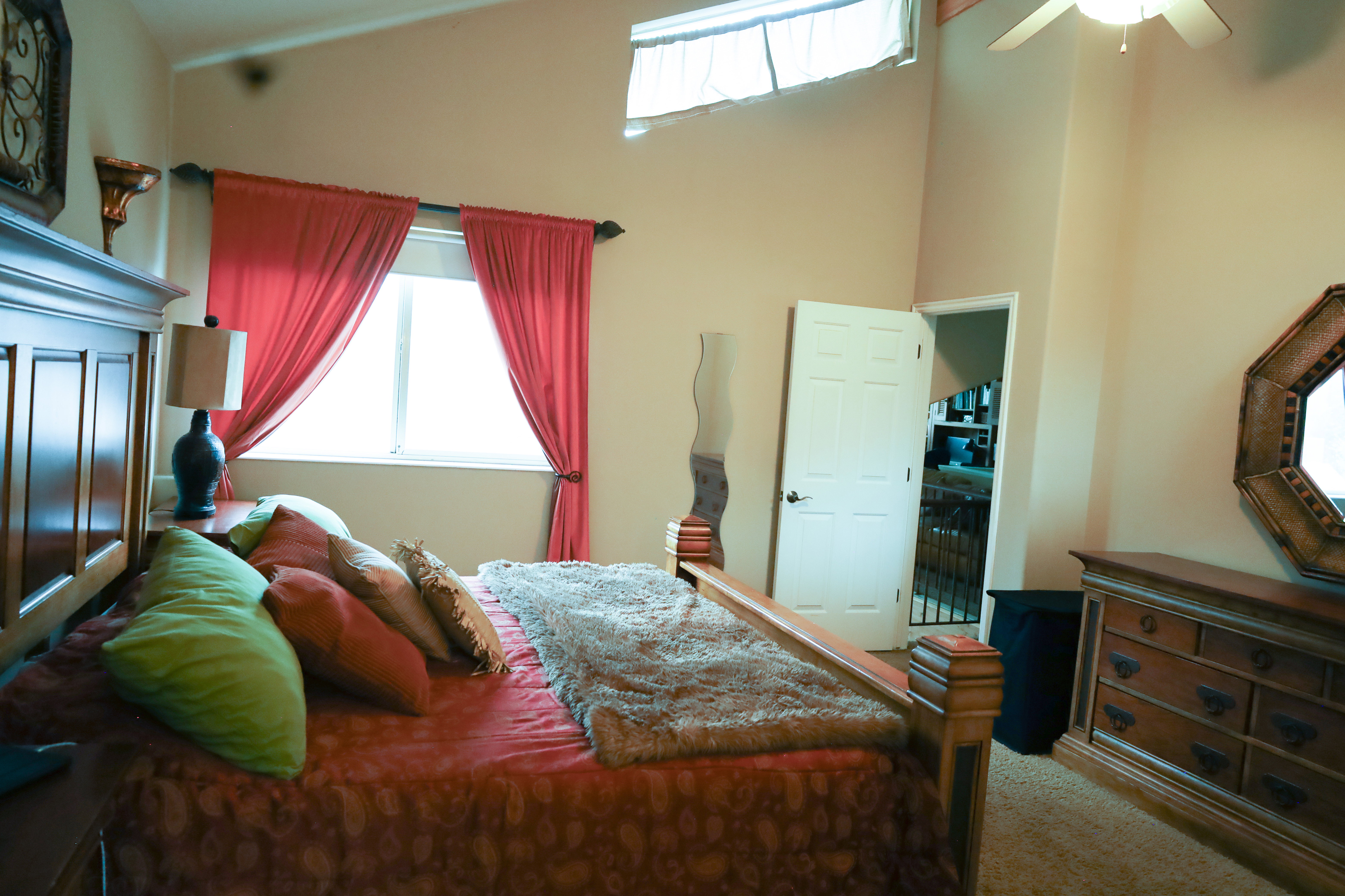 Bedroom featuring a high ceiling and ceiling fan