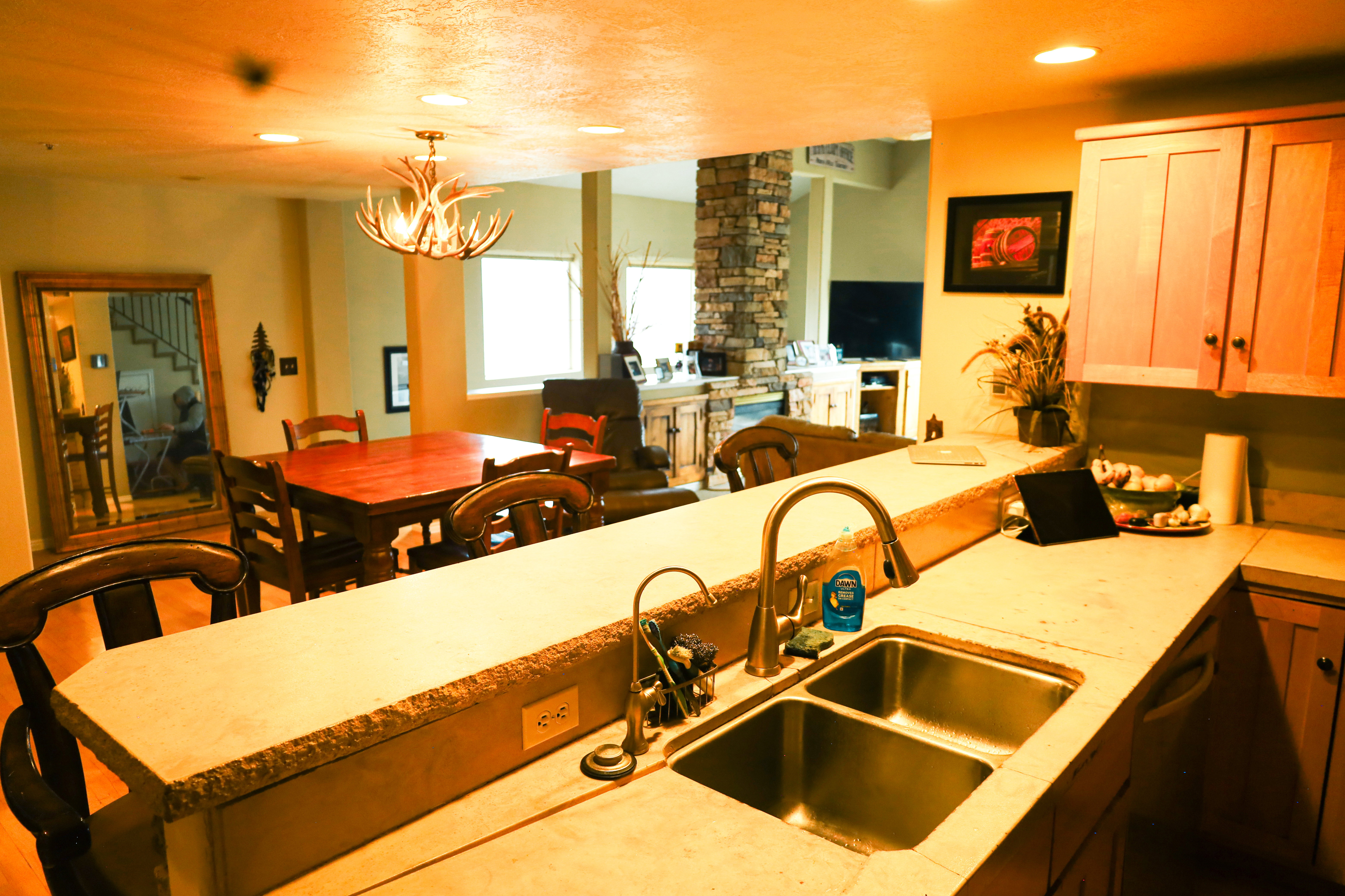 Kitchen with light countertops, open floor plan, and a chandelier