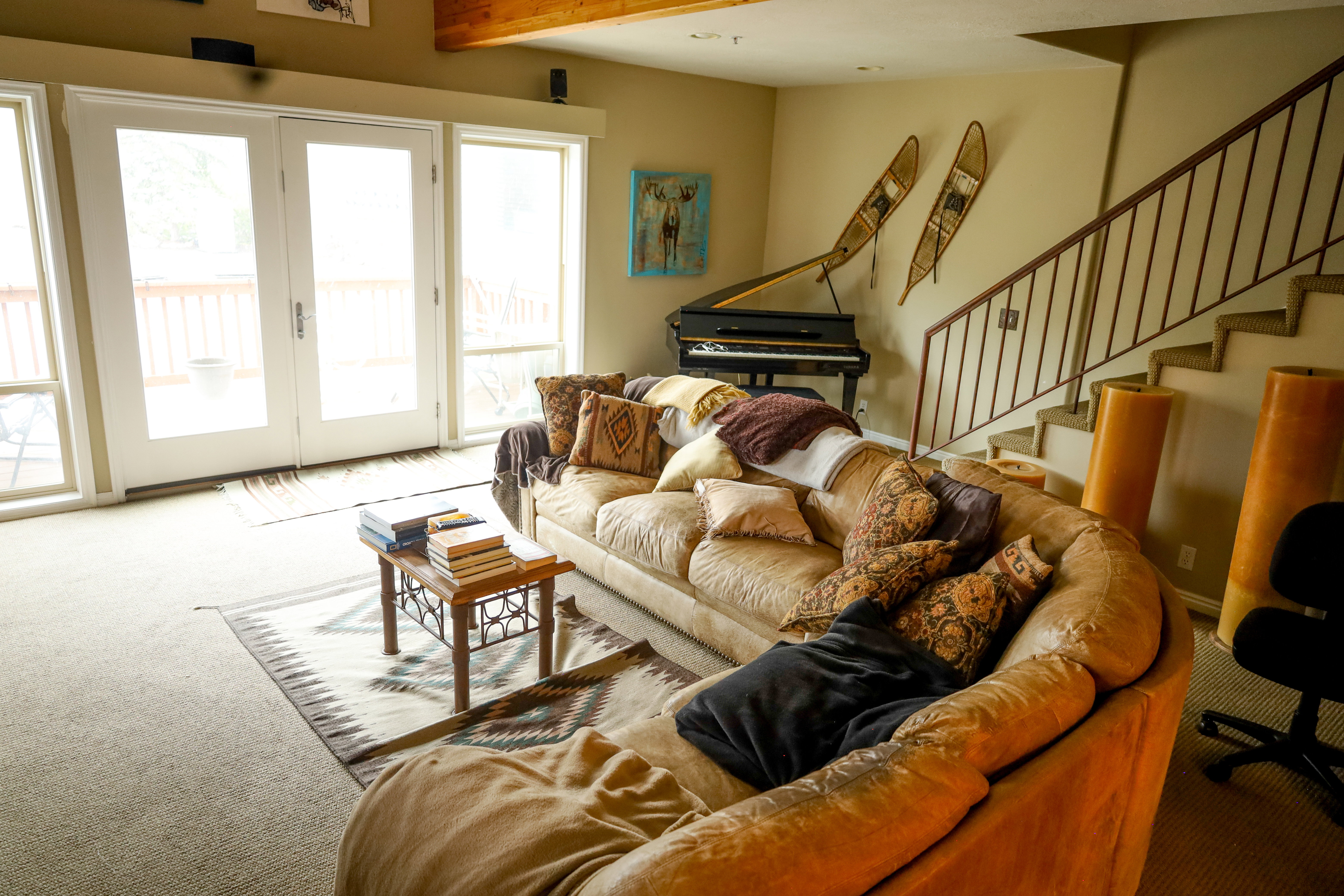 Living room with carpet flooring, french doors, and beam ceiling