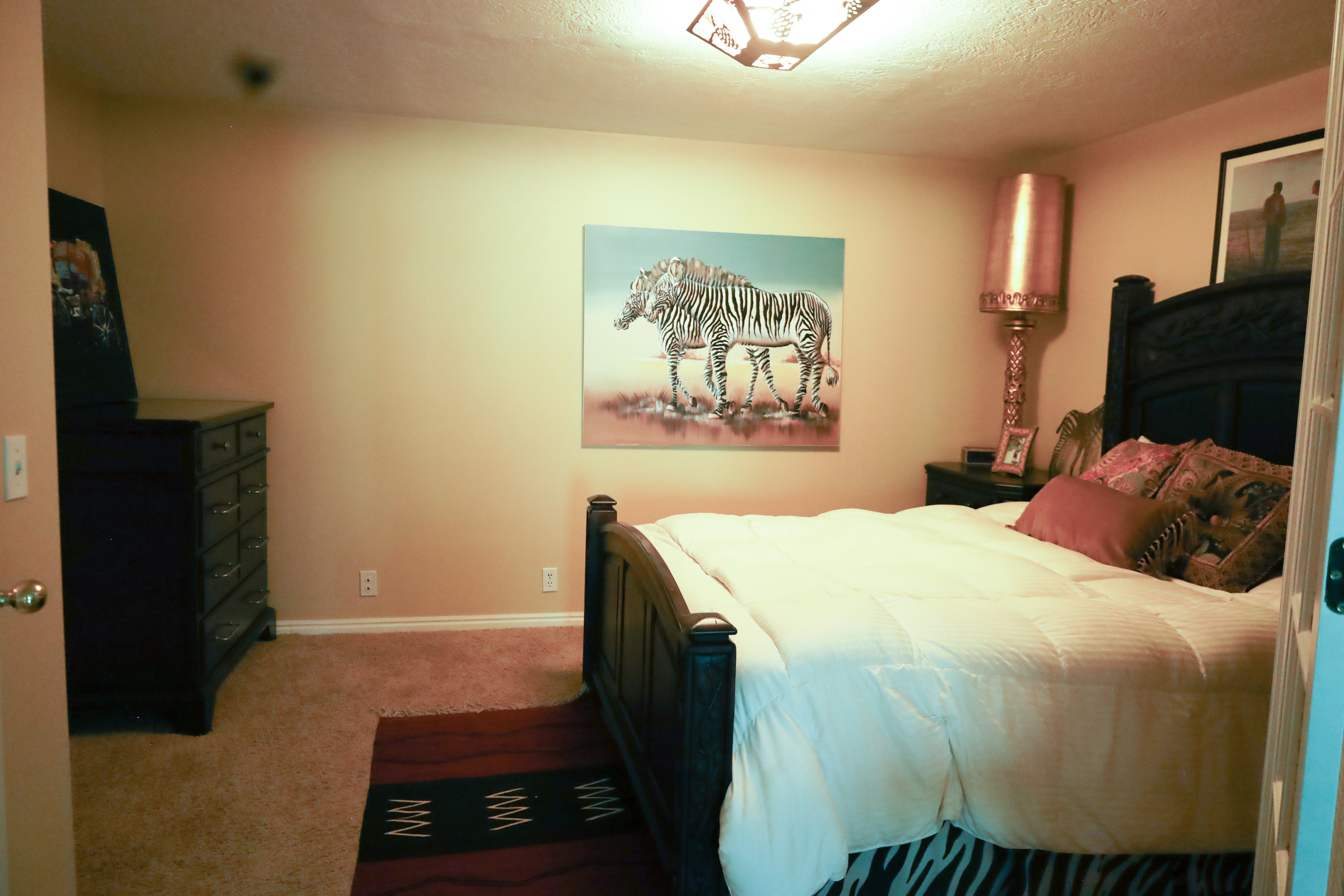 Bedroom featuring light colored carpet and baseboards