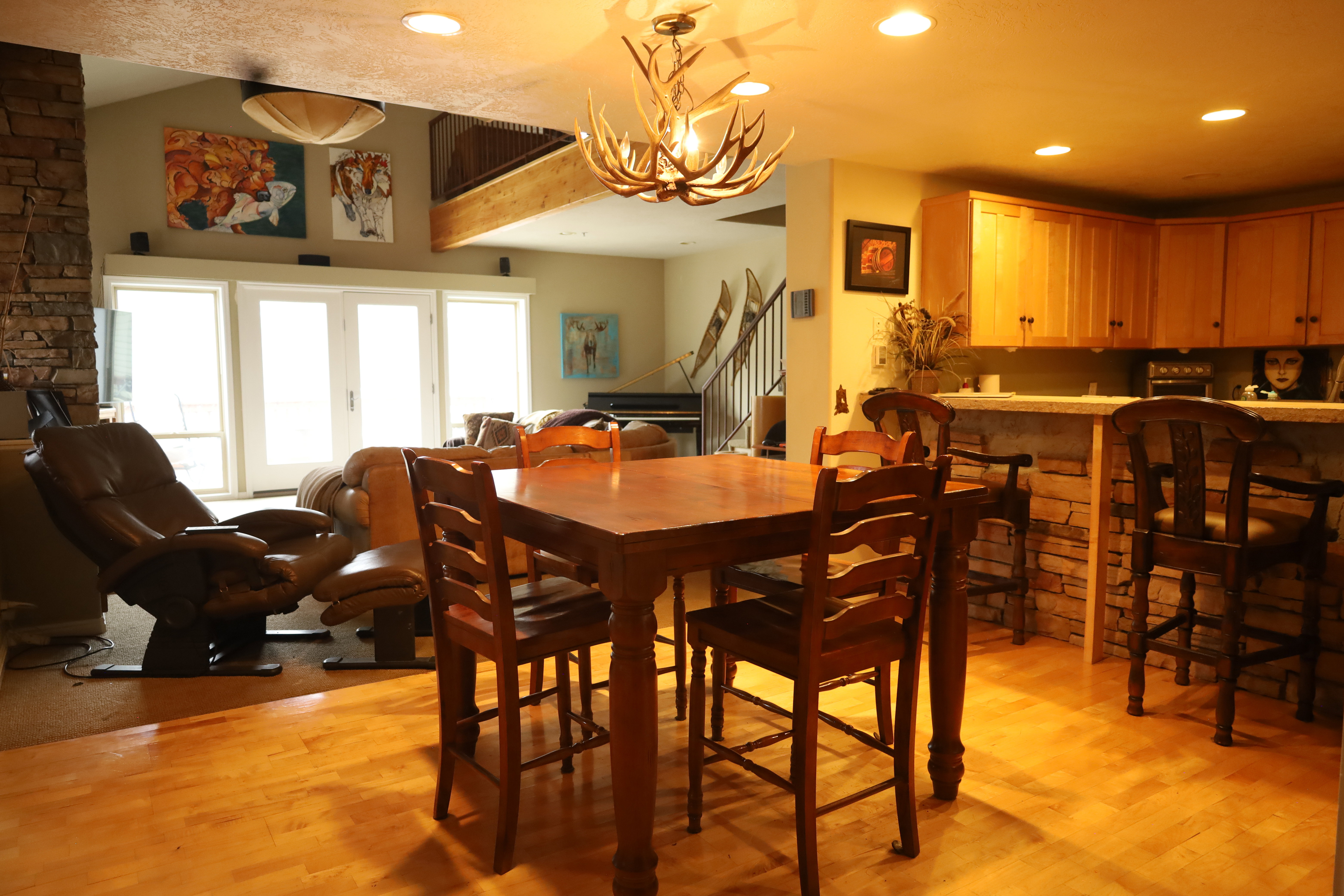 Dining room with suspended lighting and light wood finished floors