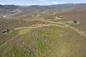 Aerial view of property's location featuring a mountainous background and rural landscape