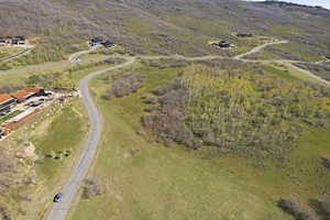 Aerial view of property and surrounding area featuring a heavily wooded area