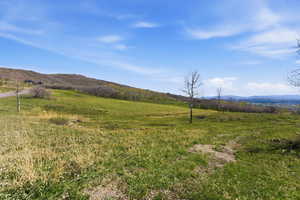 View of mountain background featuring rural landscape