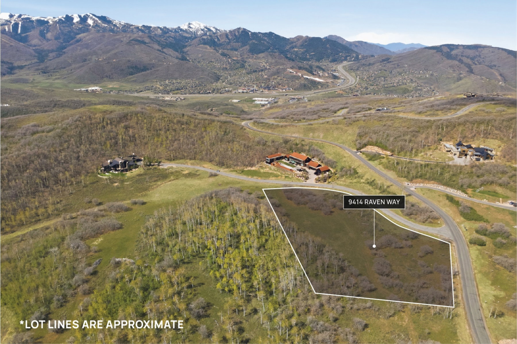 Aerial view of property's location with property boundaries highlighted and a mountainous background