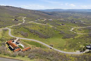 Aerial view of property and surrounding area with a mountain backdrop