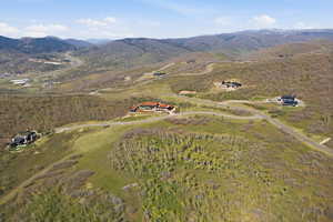 Aerial view of property and surrounding area with mountains
