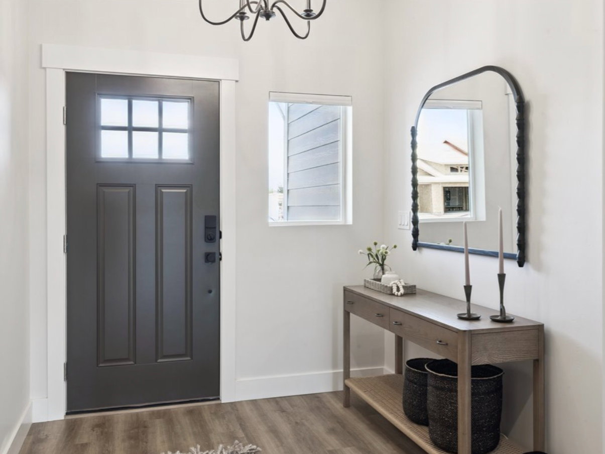 Entrance foyer with wood finished floors and a chandelier