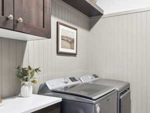 Laundry room featuring cabinet space and independent washer and dryer