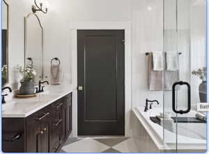 Bathroom featuring double vanity, a bath, and a shower stall
