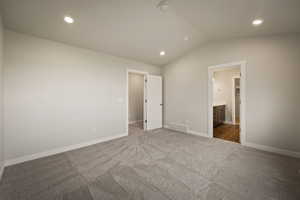 Unfurnished bedroom featuring carpet, recessed lighting, and ensuite bath