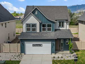 Craftsman house featuring a mountain view, a gate, a garage, concrete driveway, and a porch