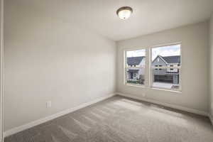 Spare room with light colored carpet and baseboards