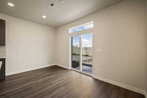 Unfurnished room with dark wood finished floors and recessed lighting