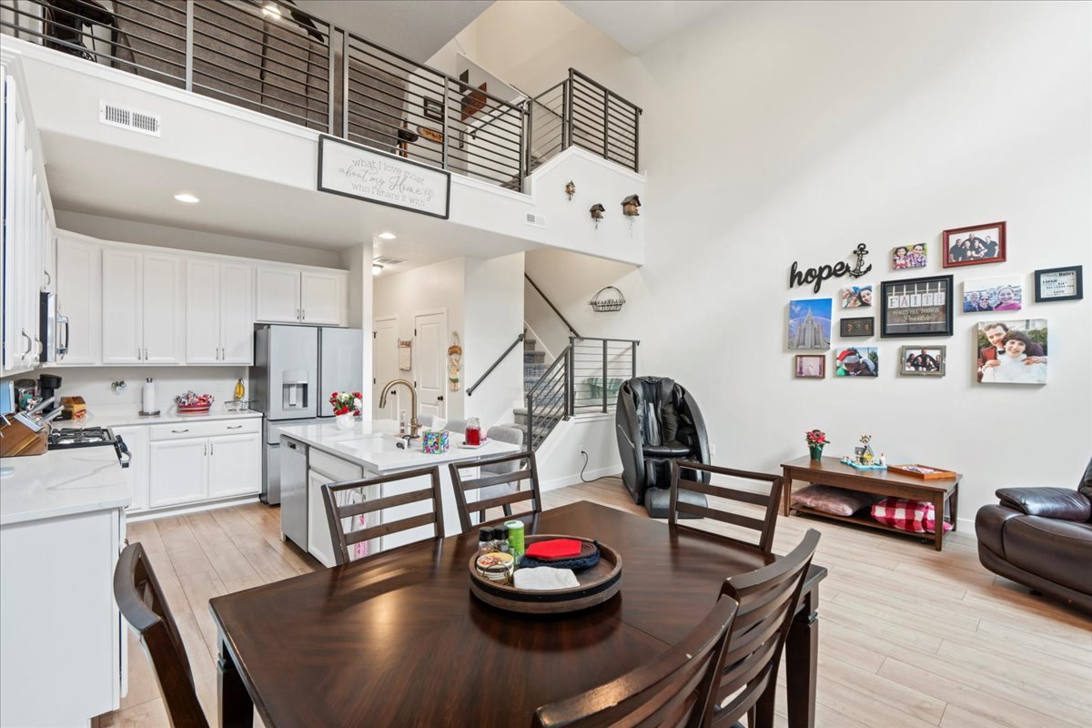 Dining room featuring a high ceiling and light wood finished floors