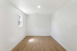 Unfurnished room featuring baseboards and light wood-style floors
