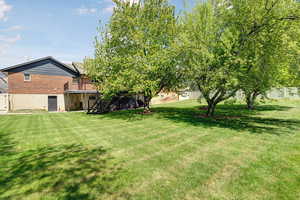 Fenced backyard featuring stairway and a deck