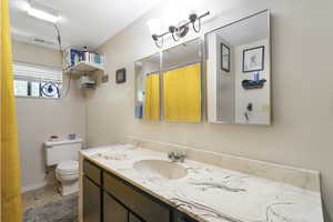 Bathroom featuring a shower with curtain and vanity
