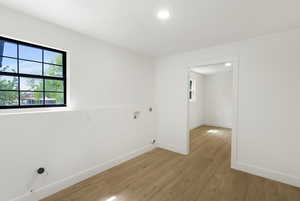 Spare room with baseboards and light wood finished floors