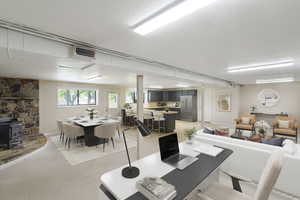 Dining room with a wood stove and a textured ceiling