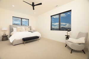 Carpeted bedroom featuring ceiling fan and recessed lighting
