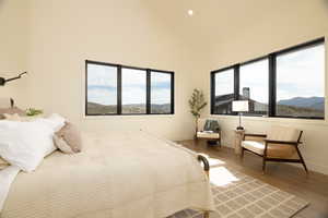 Bedroom featuring a mountain view, wood finished floors, recessed lighting, and vaulted ceiling