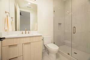 Bathroom featuring vanity, a stall shower, and light tile patterned flooring