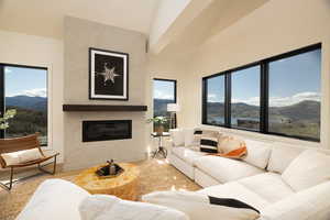 Living room with a mountain view, a high end fireplace, and healthy amount of natural light