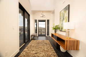 Entryway with baseboards and vaulted ceiling