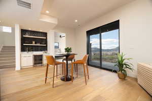 Dining room featuring healthy amount of natural light, a mountain view, light wood finished floors, and recessed lighting