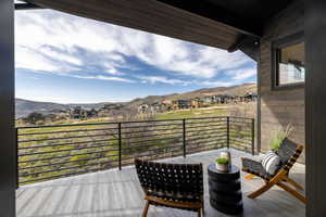 Wooden deck with a residential view and a mountain view