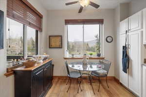 Dining space featuring light wood-style flooring and ceiling fan