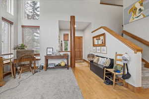 Living area with a high ceiling and light wood finished floors