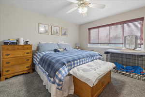 Bedroom with dark carpet and ceiling fan