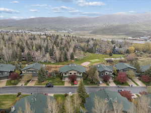 Aerial view of property's location featuring mountains and nearby suburban area