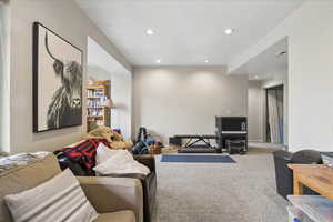 Carpeted living room with recessed lighting