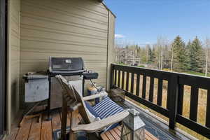 Wooden terrace featuring grilling area