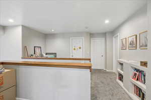 Bar area with light colored carpet, built in features, and recessed lighting