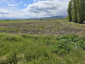 View of mountain backdrop featuring rural landscape