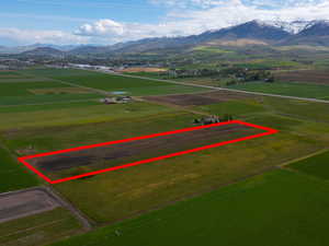 Overview of rural landscape featuring mountains and large plots for crops