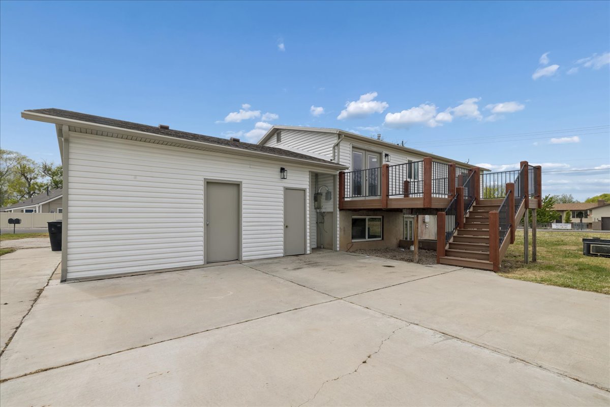 Back of house with a deck and stairs