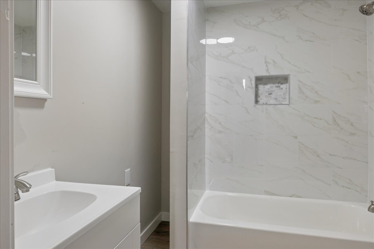 Full bathroom featuring vanity and shower / washtub combination