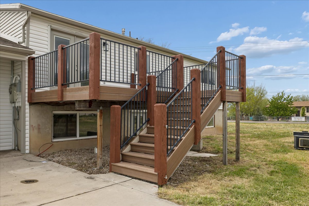 Wooden deck featuring stairway and a yard