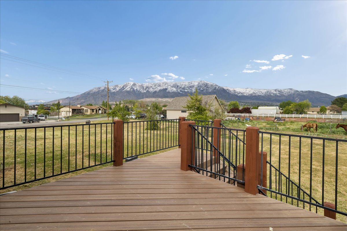 Deck with a yard, a residential view, and a mountain view