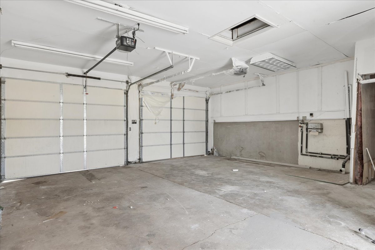 Garage featuring a garage door opener