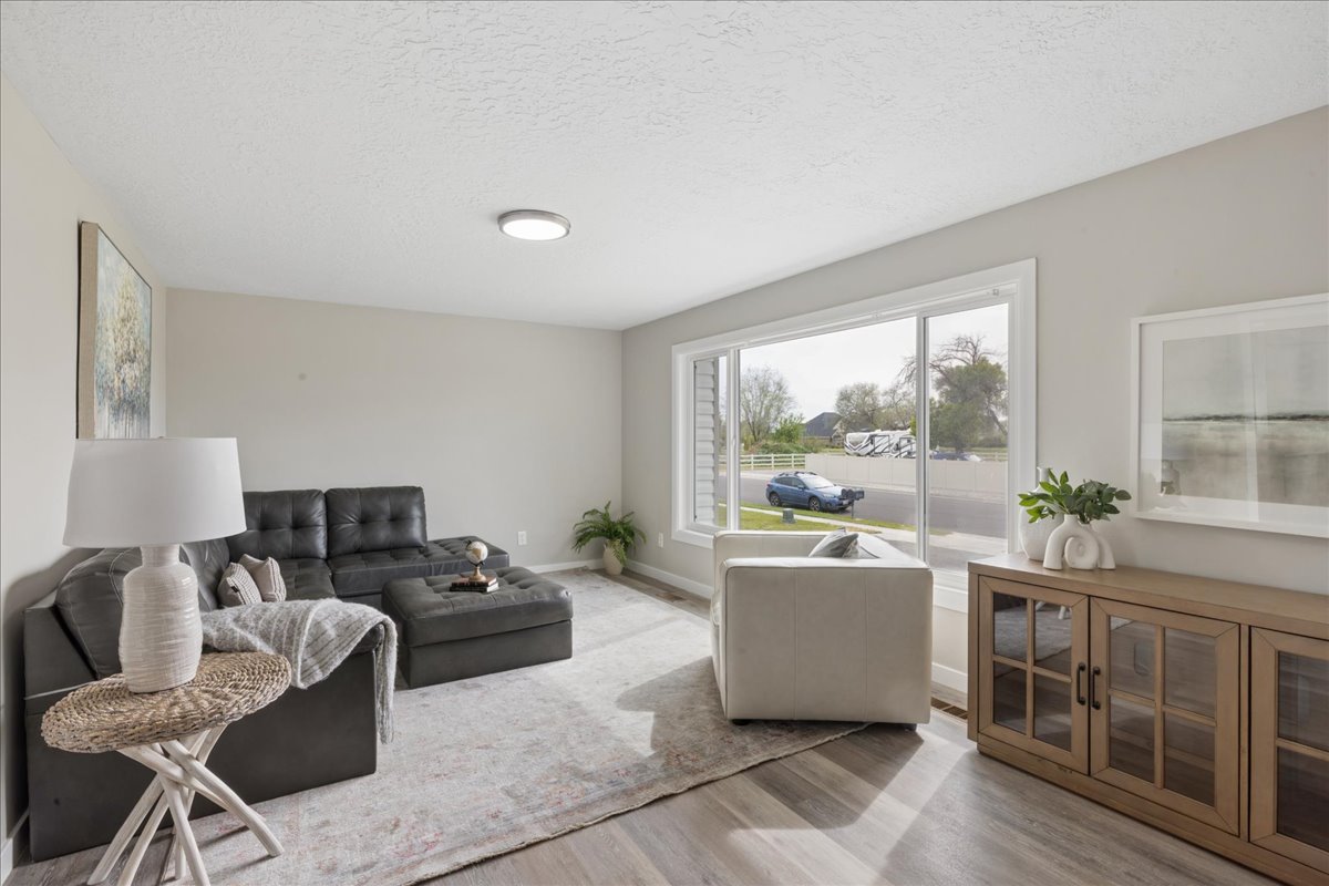 Living area with light wood finished floors and a textured ceiling