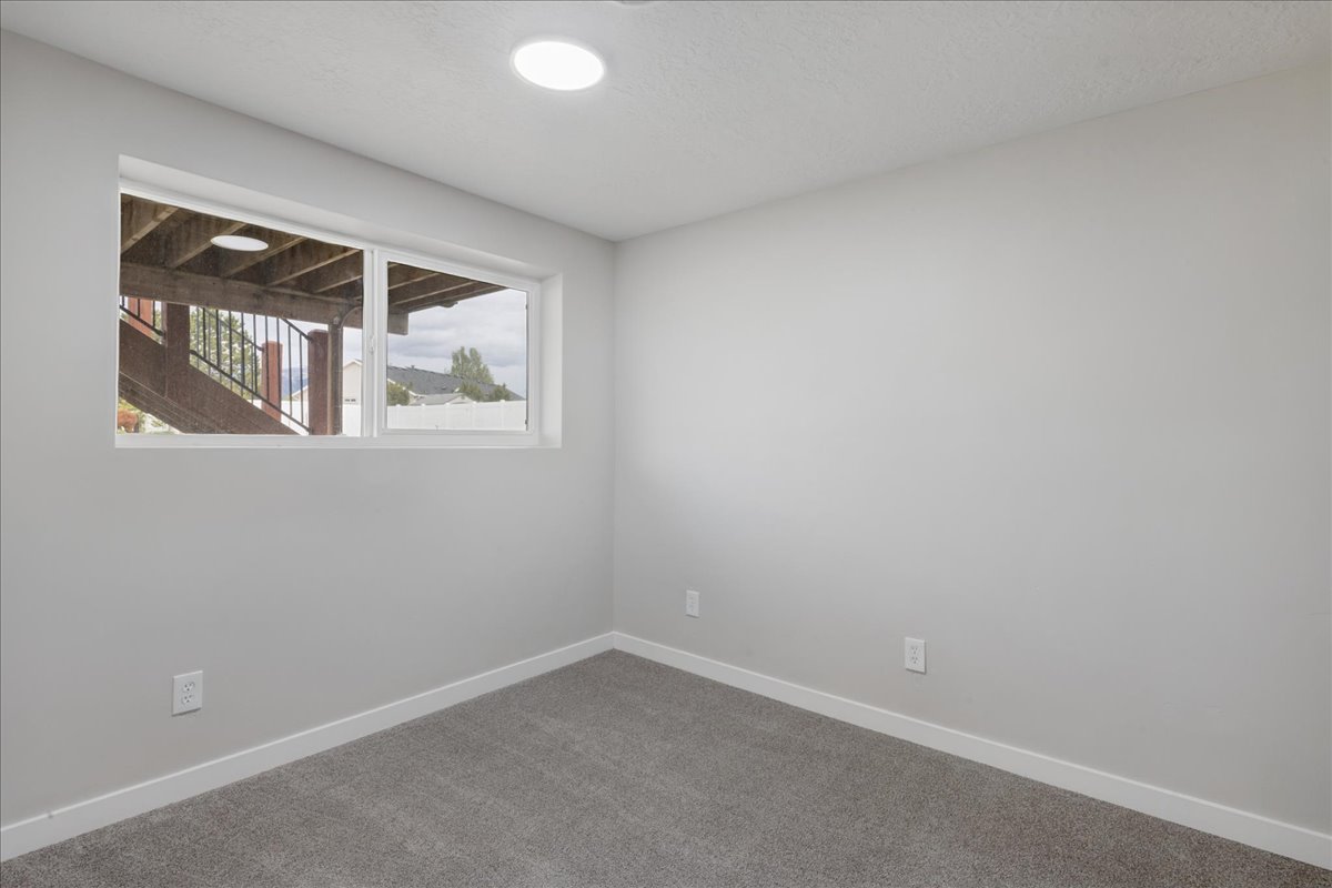 Unfurnished room with carpet floors and a textured ceiling